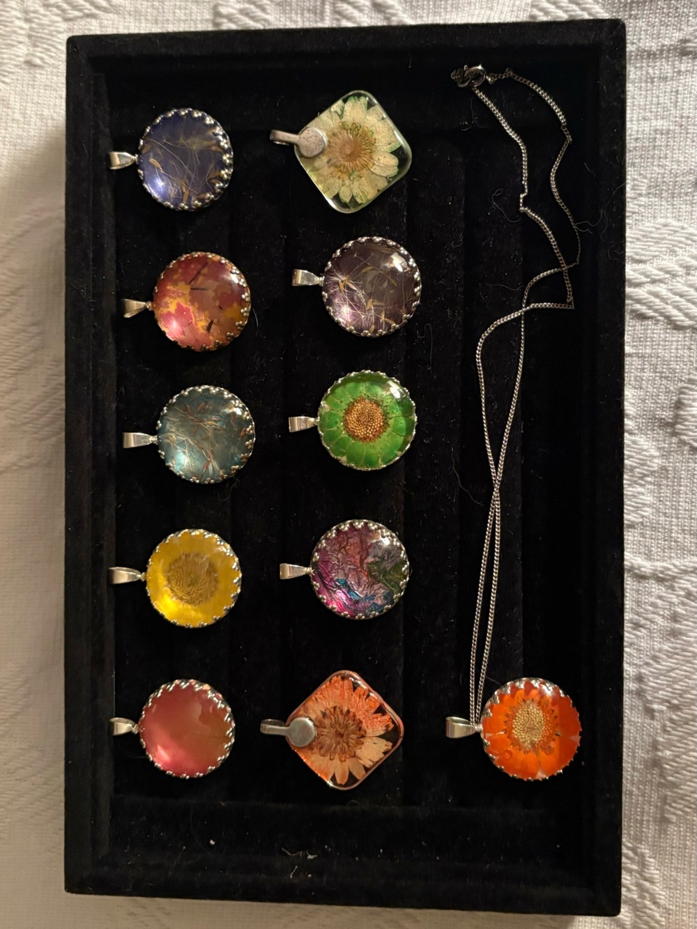 Multi colored necklace pendants with silver toned chain.  Set of 11